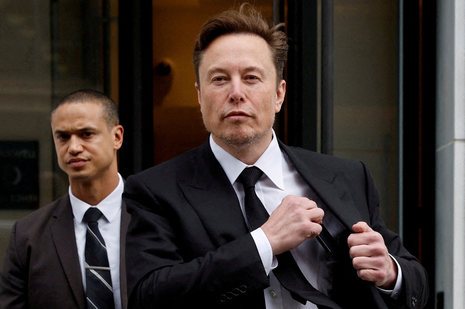 How much does Elon Musk get paid to work at his company Tesla?